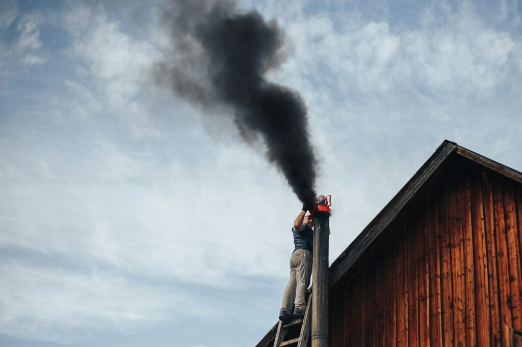 man clean chimney with the help of wacum